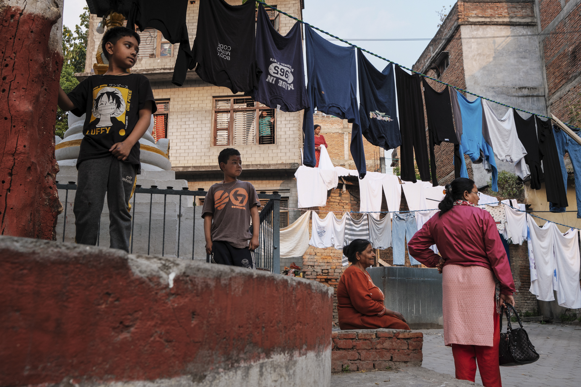 Children playing and clothes hanging in a courtyard in Kathmandu, Nepal.