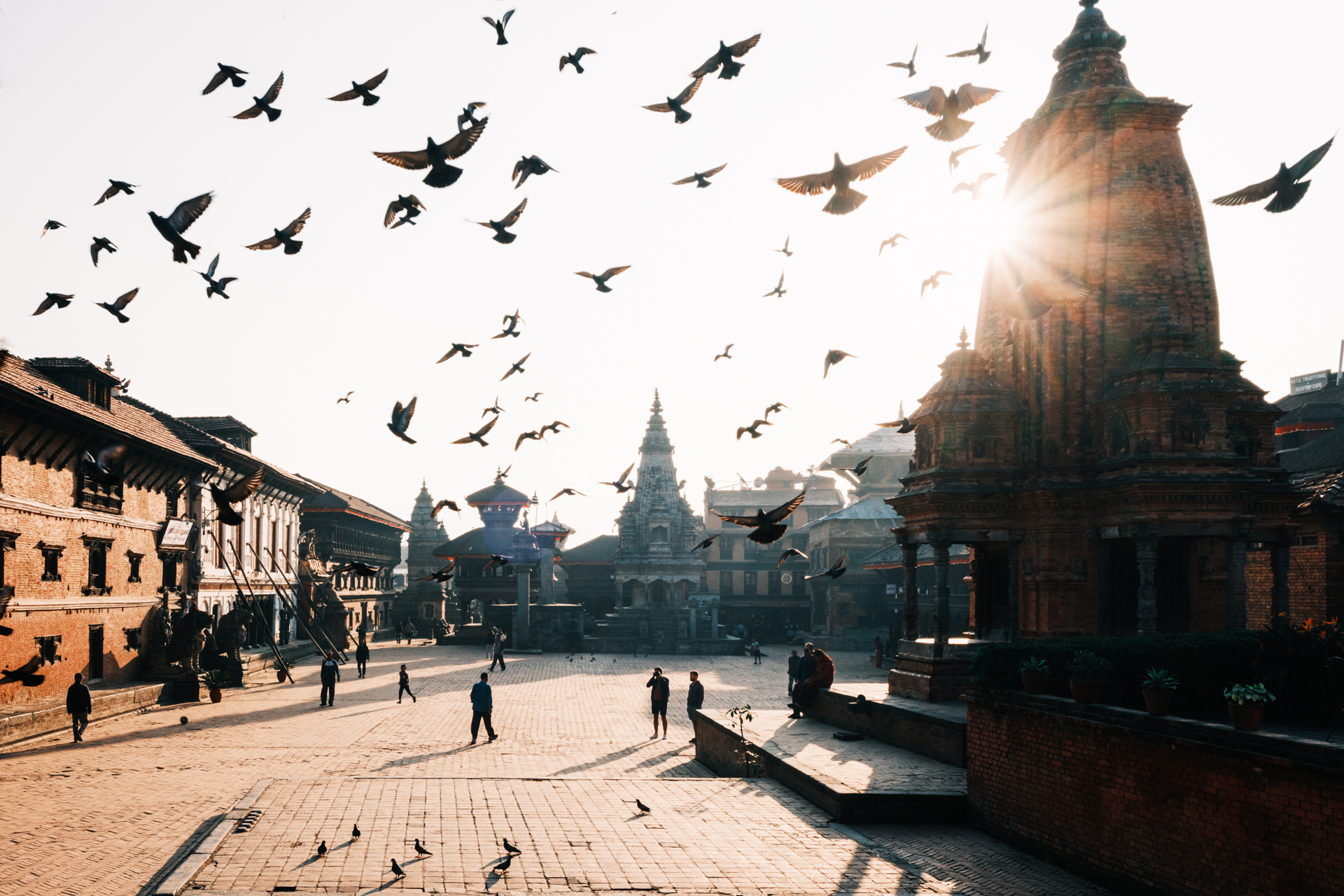 Birds flying over Bhaktapur Durbar Square at sunrise during Kaag Tihar, the first day of the festival