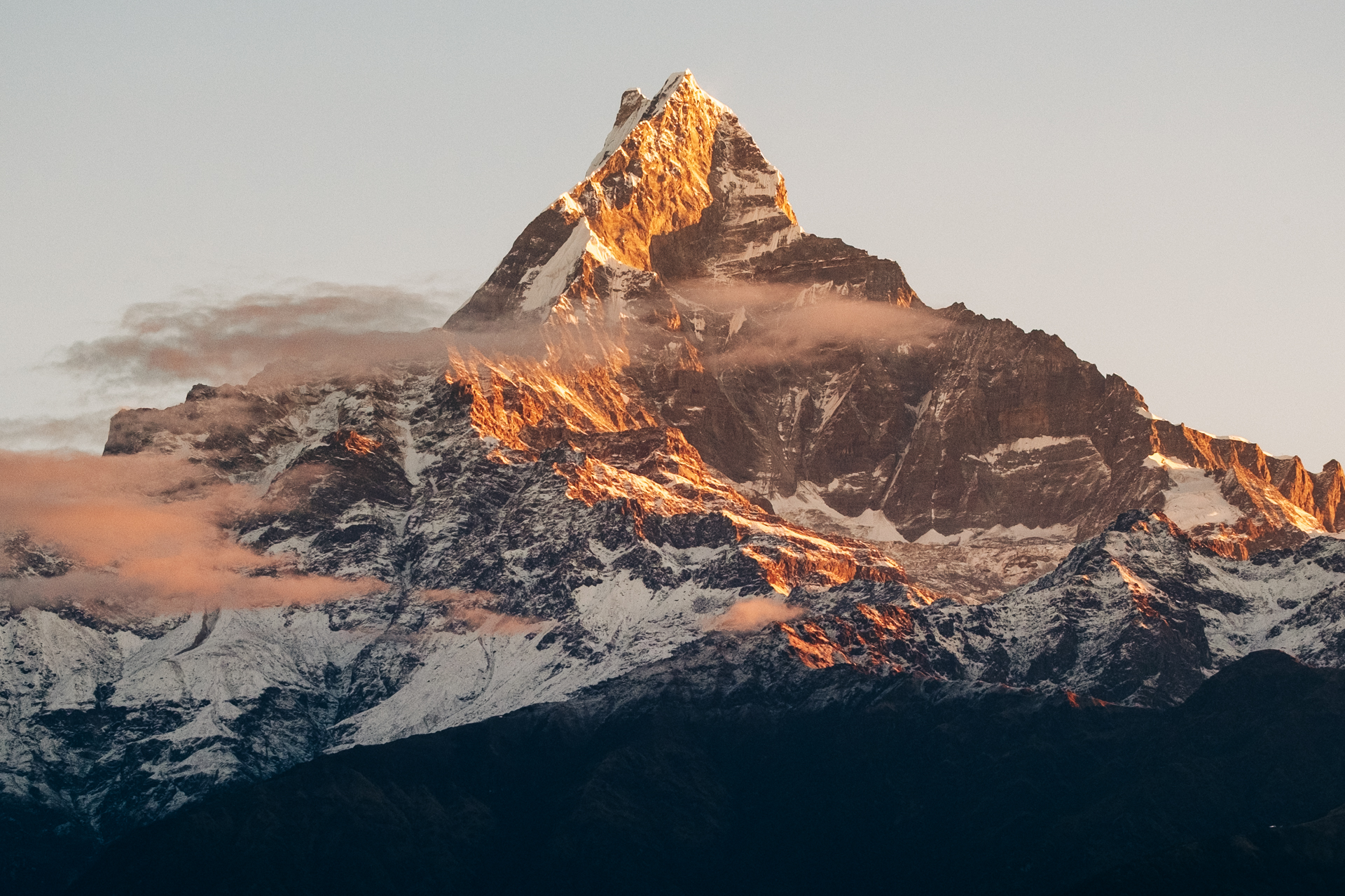 Golden light hitting the peak of Machapuchare mountain at dawn – iconic sunrise on Nepal photo tour